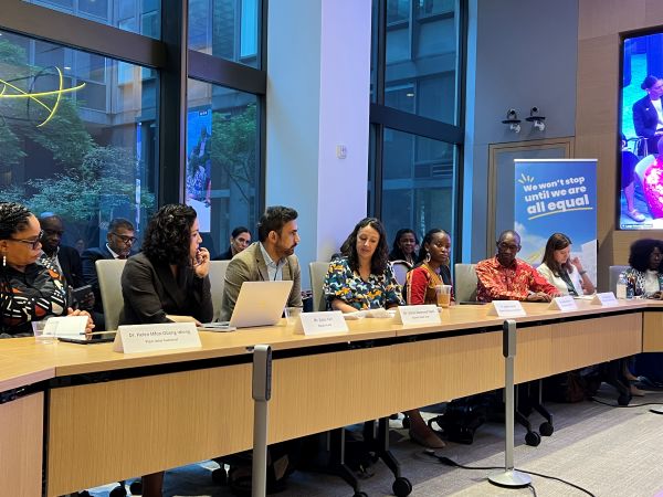 people at a table for a panel discussion