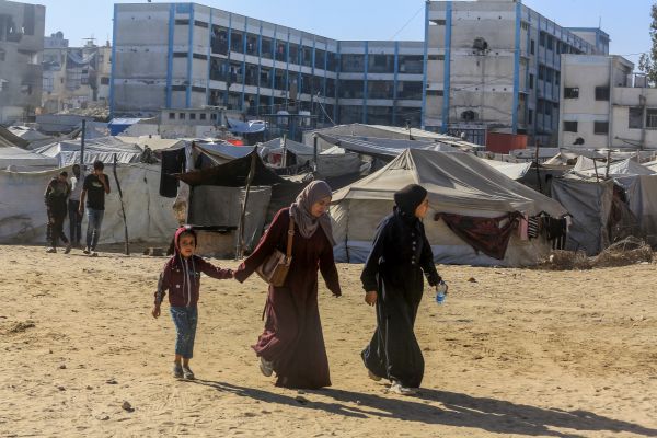 women walk with a child in Gaza