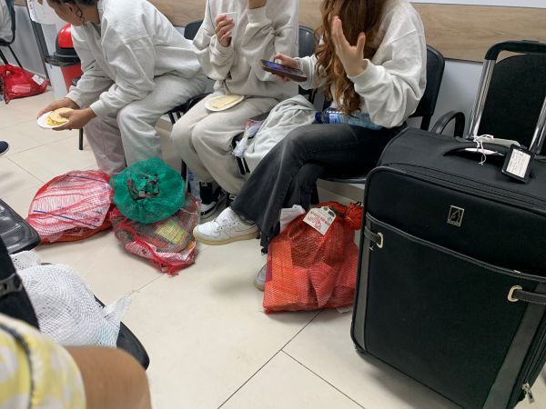 deported women sit with their belongings