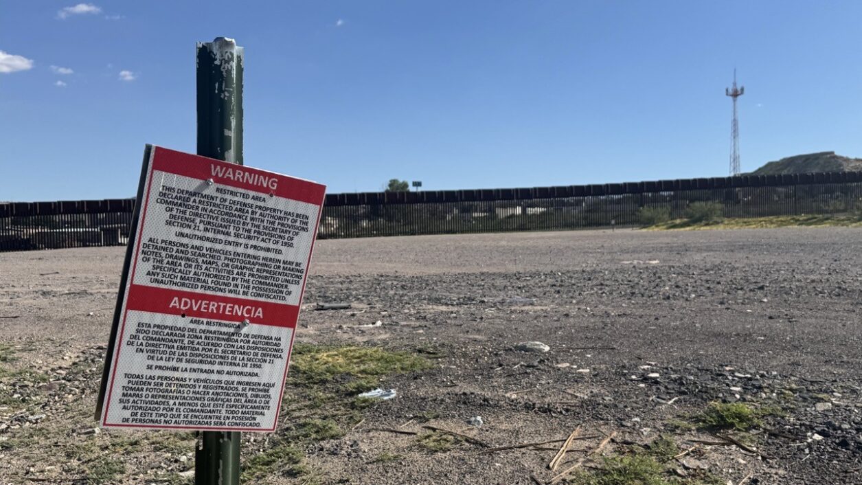 A sign by the border wall