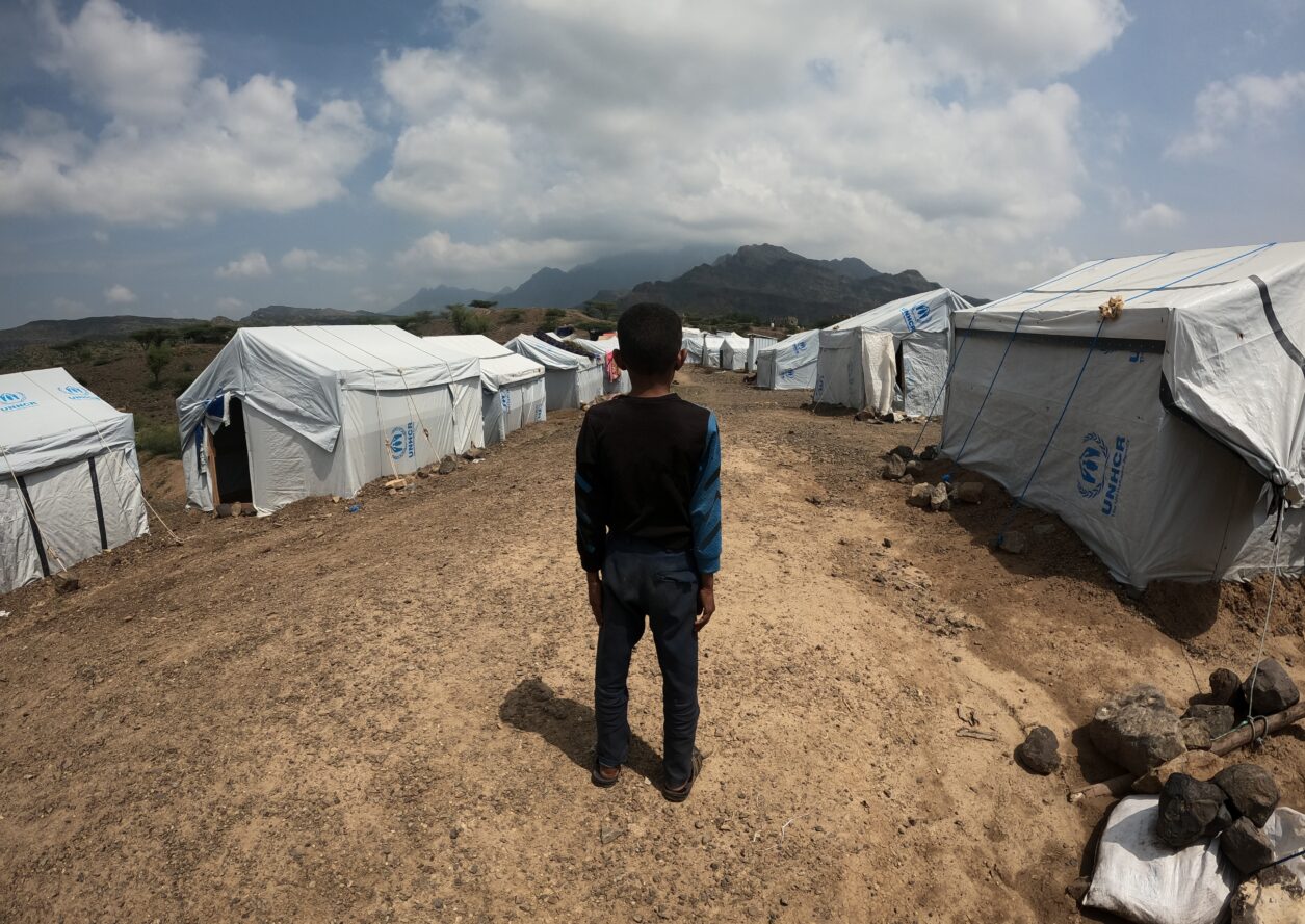 boy and UNHCR tents