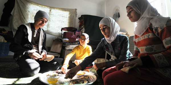 Syrian refugee children have breakfast in their rented room in Ramtha on the Jordan-Syria border.  © Peter Biro/IRC